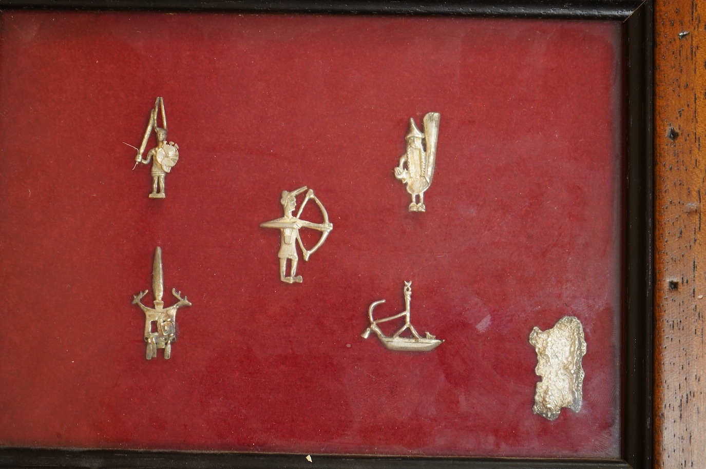 A Roman bronze badge, a medieval pewter badge and silver badges in the form of Sardinia emblems all framed., Swan badge 6cm wide, not including mount or frame. (Requires provenance)